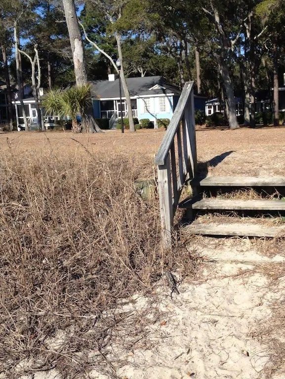 There are stairs leading up to a house in the background.
