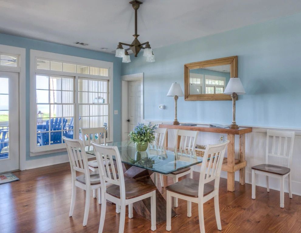 A dining room with a glass table and chairs.