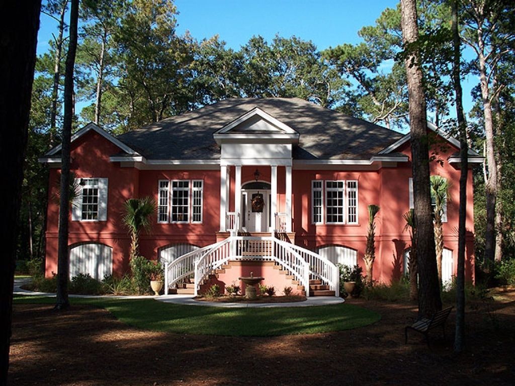 A large red house with a white porch and stairs