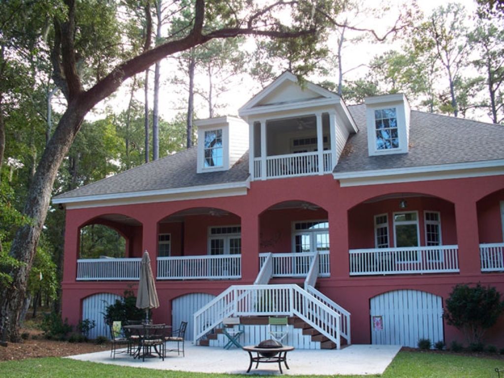 A large red house with a fire pit in front of it