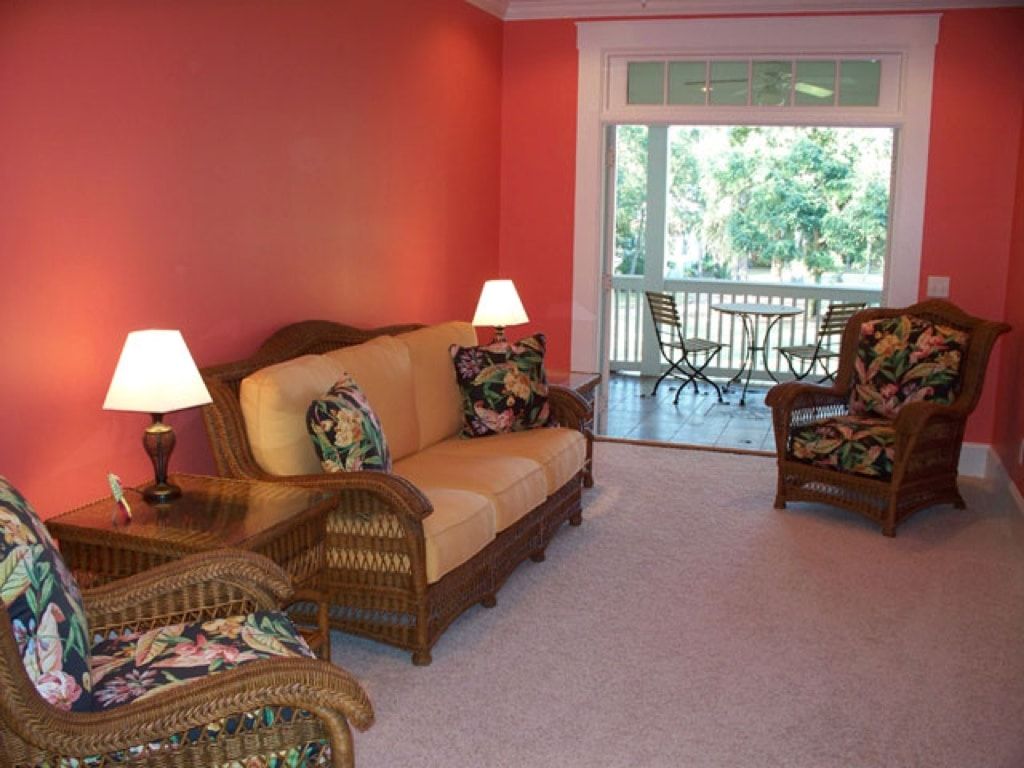 A living room with a couch and two chairs