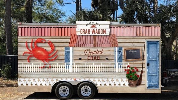 A trailer with a crab on it is parked in a parking lot.
