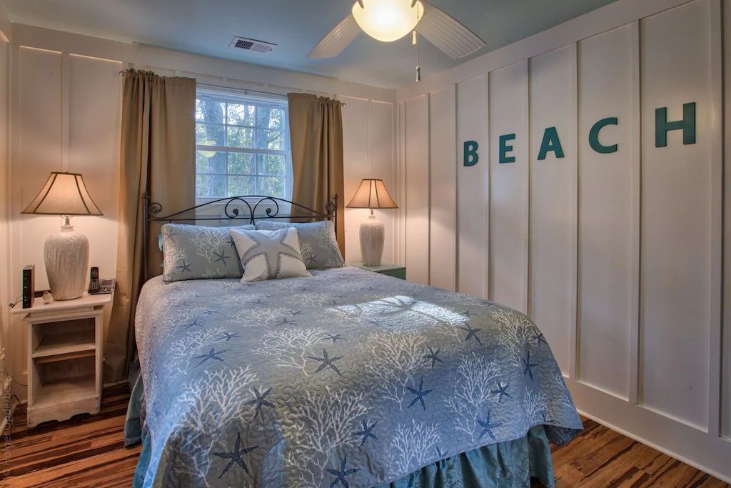 A bedroom with a bed and a sign on the wall that says beach