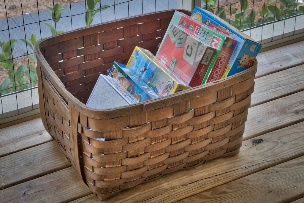 A basket filled with books on a wooden deck