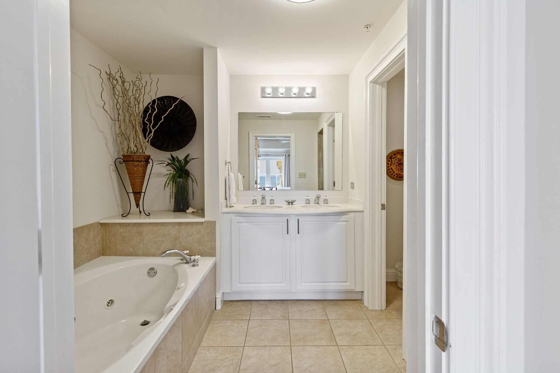A bathroom with a jacuzzi tub and two sinks