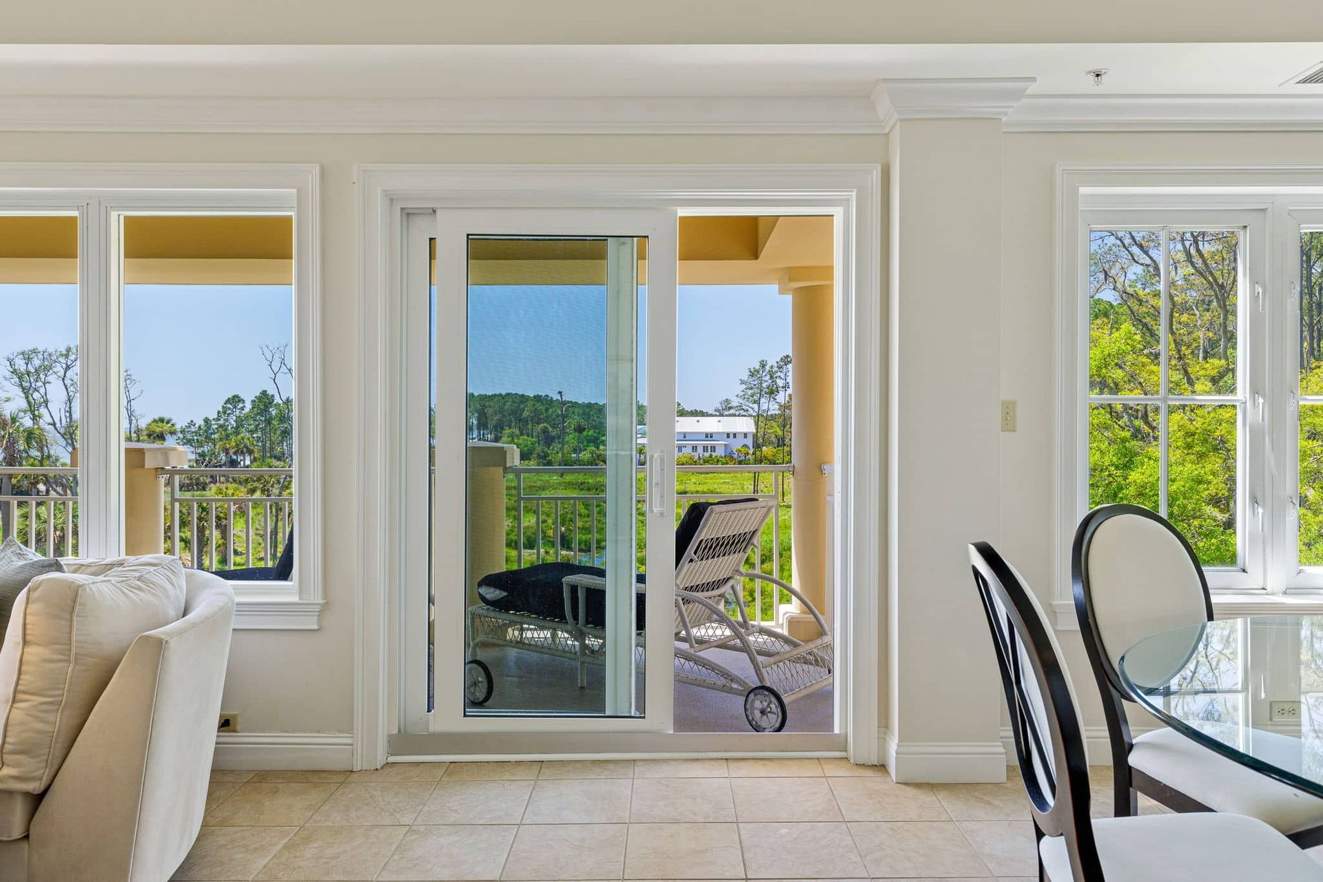 A living room with a sliding glass door leading to a balcony.