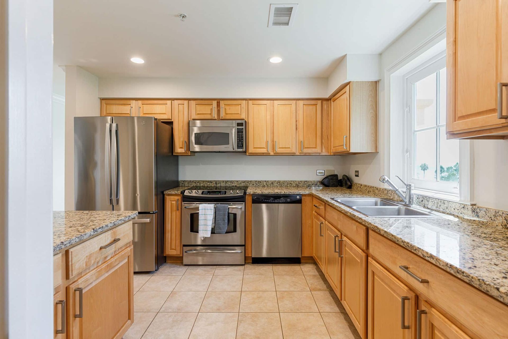 A kitchen with stainless steel appliances and wooden cabinets