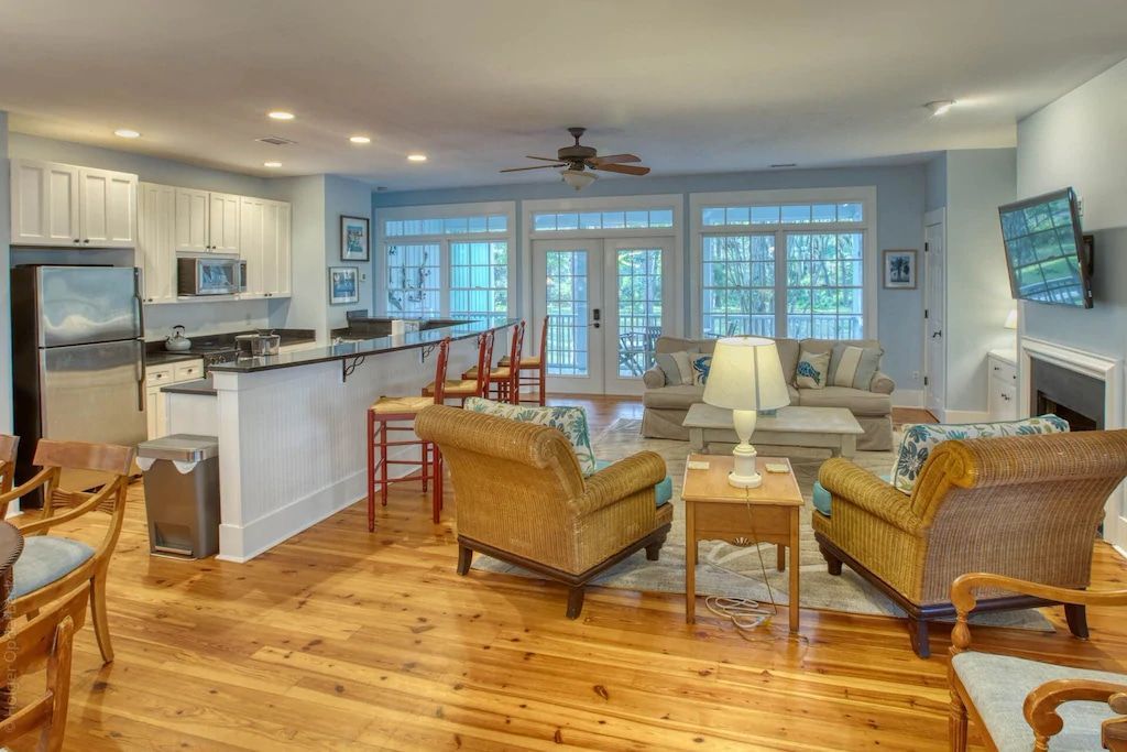 A living room filled with furniture and a kitchen.