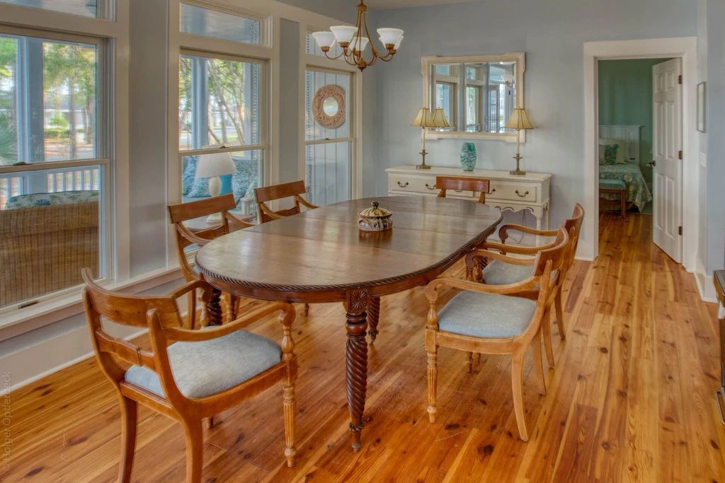 A dining room with a table and chairs and a chandelier.