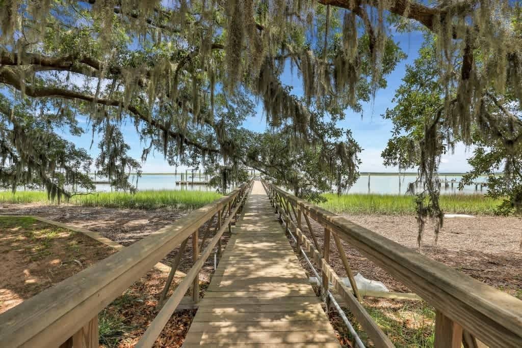 A balcony with a bench and a doorway leading to a living room.