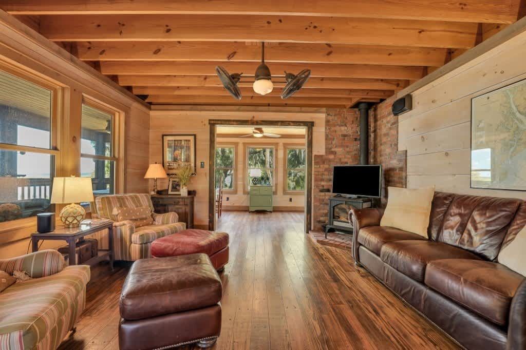 A dining room with a table and chairs and a chandelier
