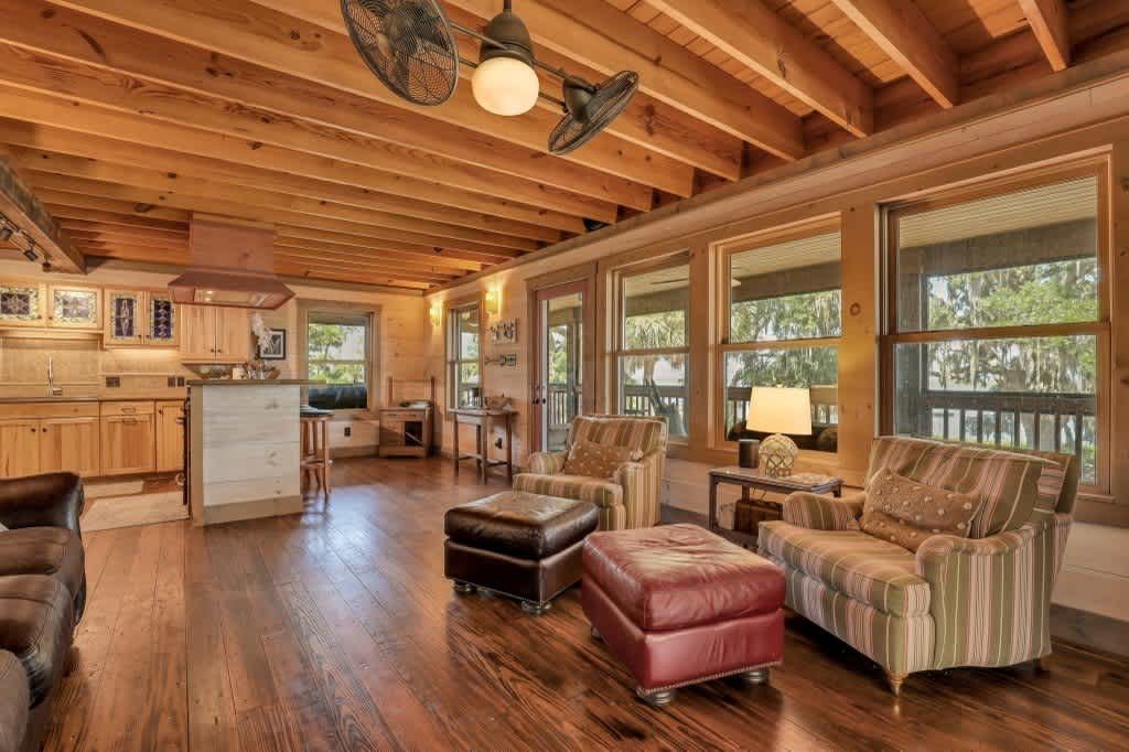 A living room filled with furniture and a rug.