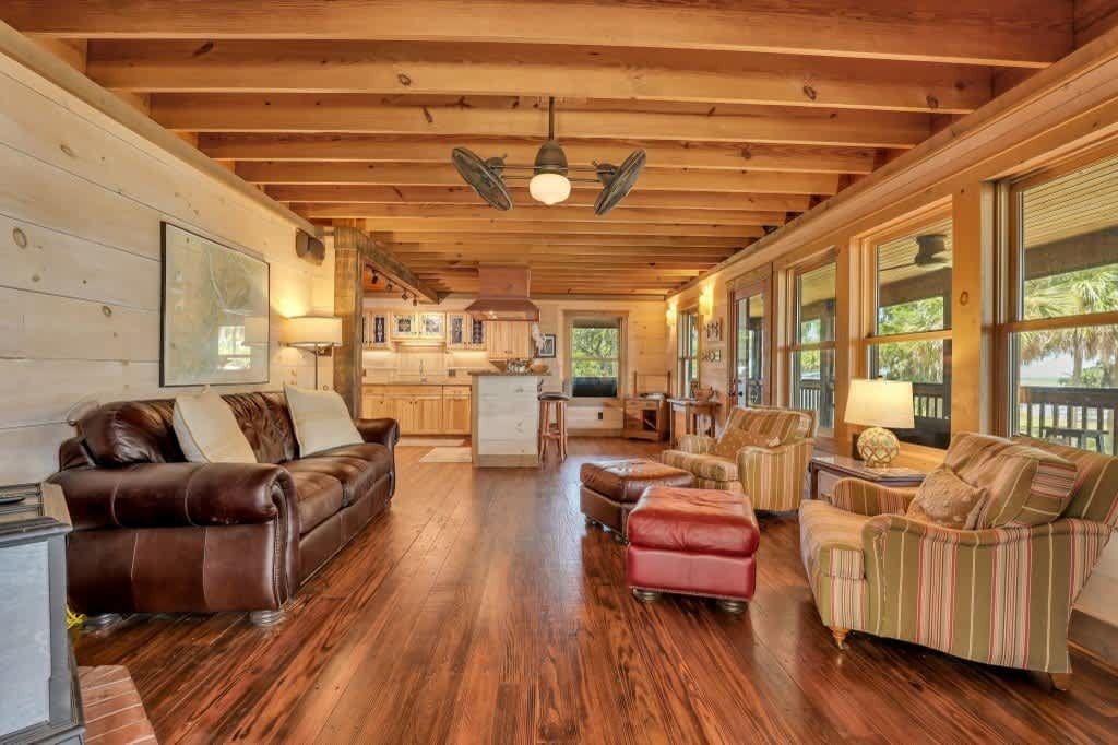 A living room with a couch , coffee table , and television.