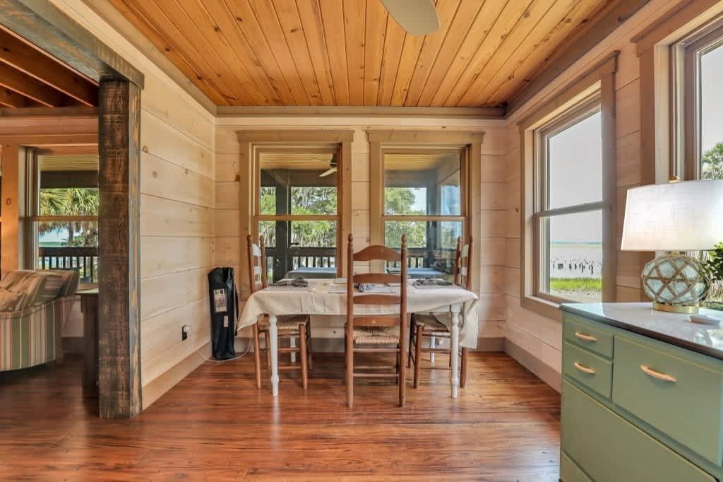 A bedroom with a large bed , dresser , and television.