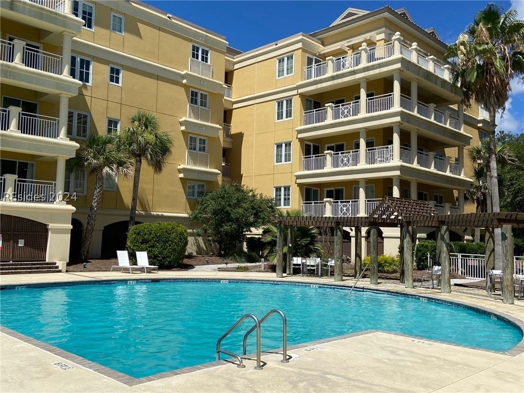 A kitchen with a wooden table and chairs and stainless steel appliances.