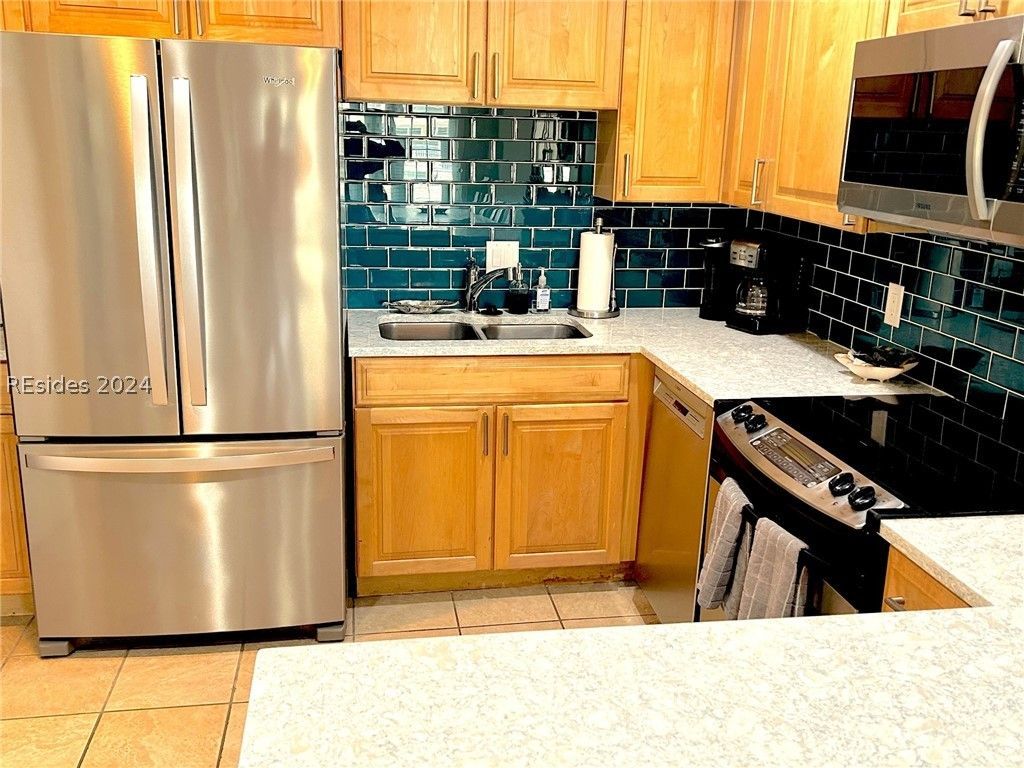 There are two rocking chairs on the porch of a house.