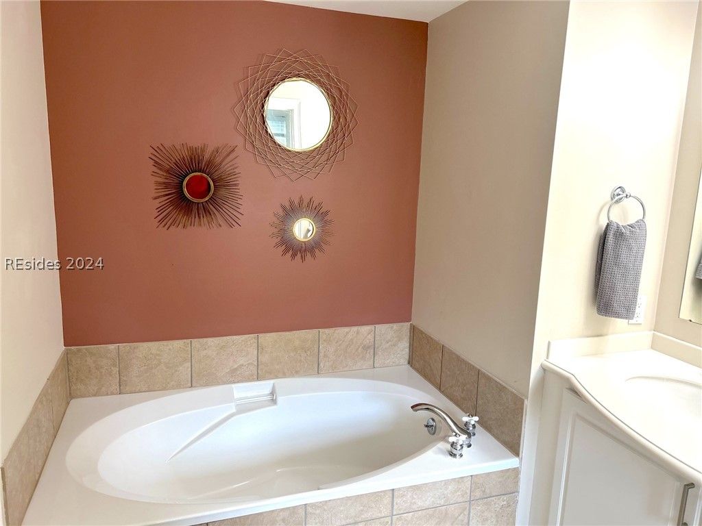 A kitchen with stainless steel appliances and a wooden table and chairs.