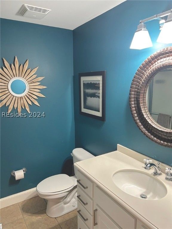 A kitchen with white cabinets , stainless steel appliances , and hardwood floors.