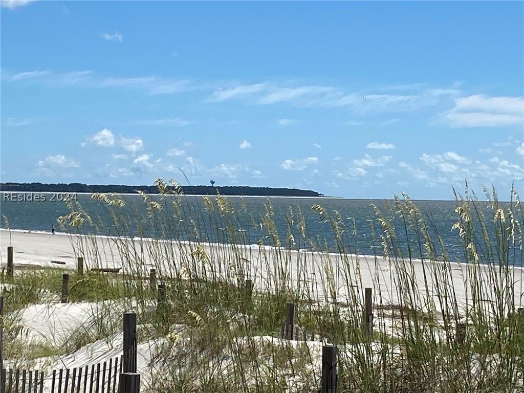 A living room with a blue couch and a dining table