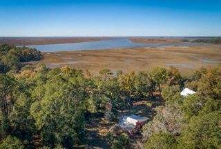 An aerial view of a large body of water surrounded by trees.
