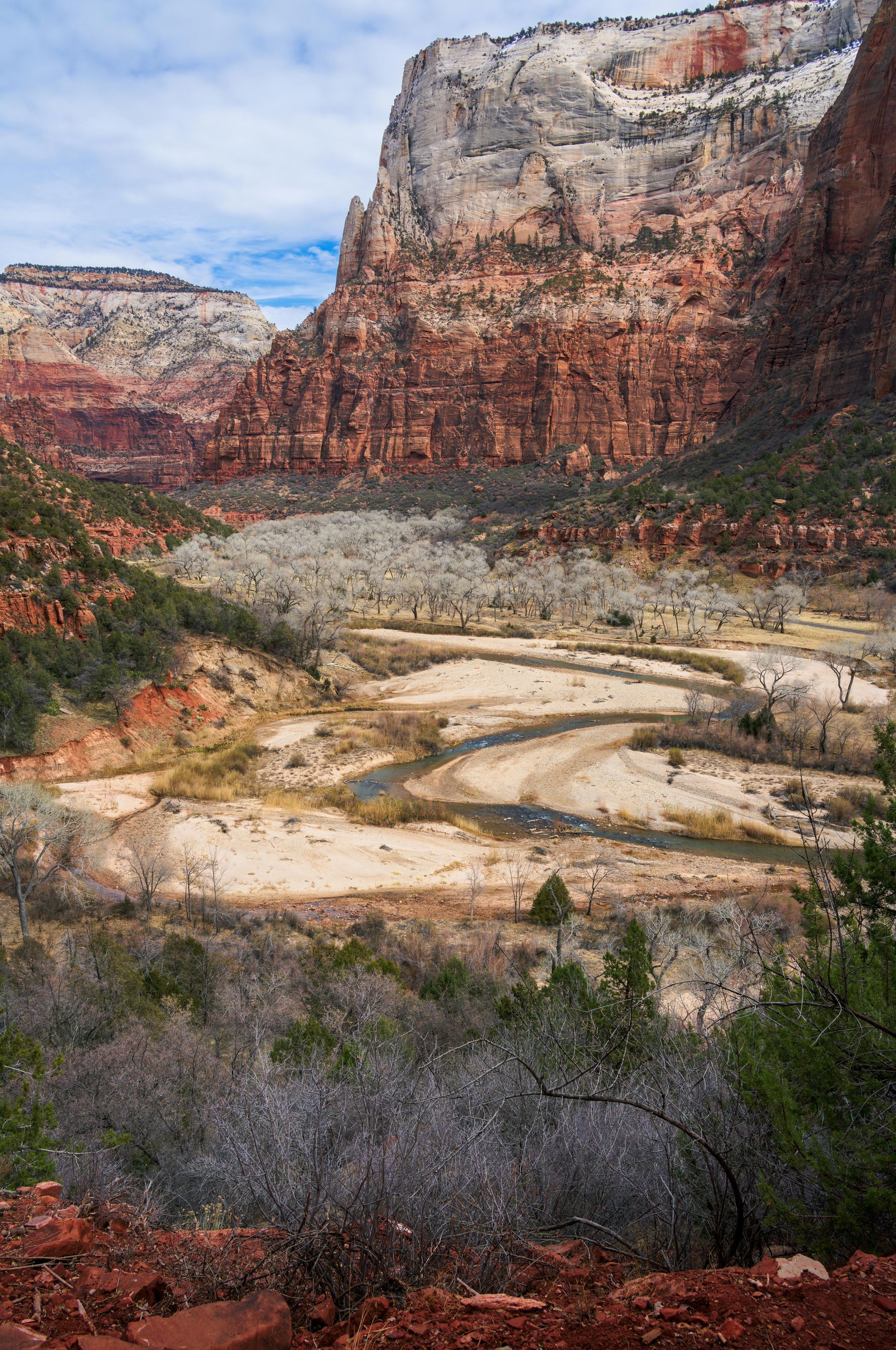 A river runs through a valley surrounded by mountains.