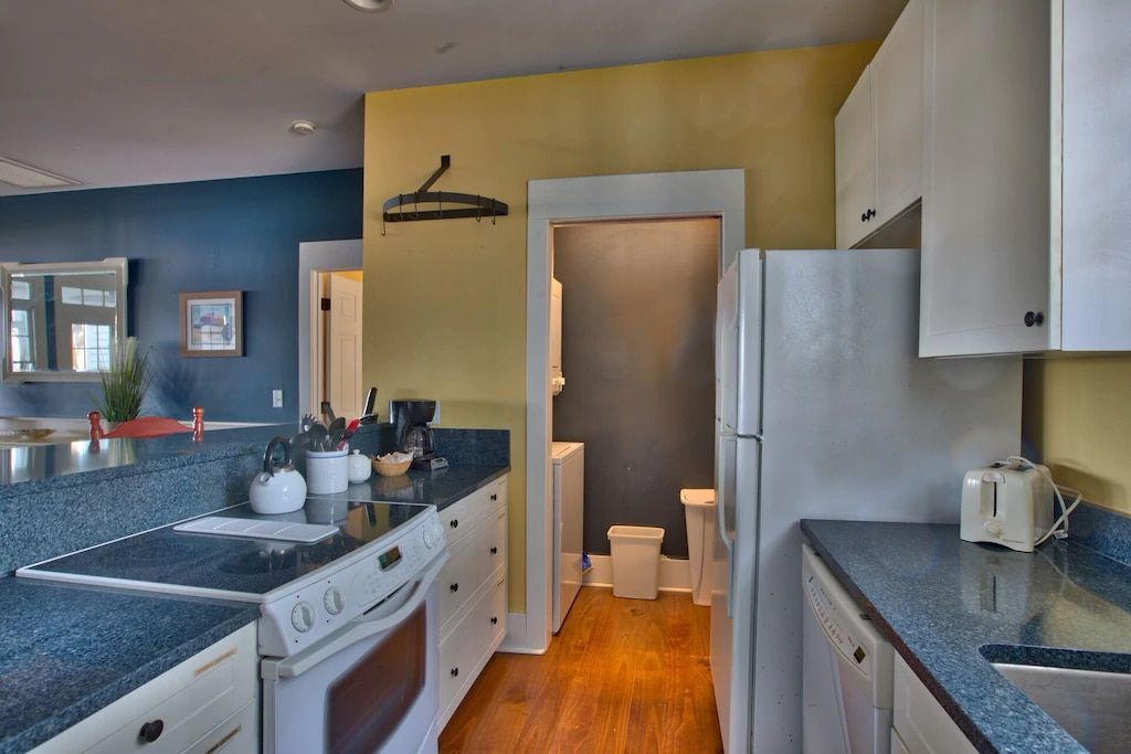 A kitchen with a refrigerator stove and sink