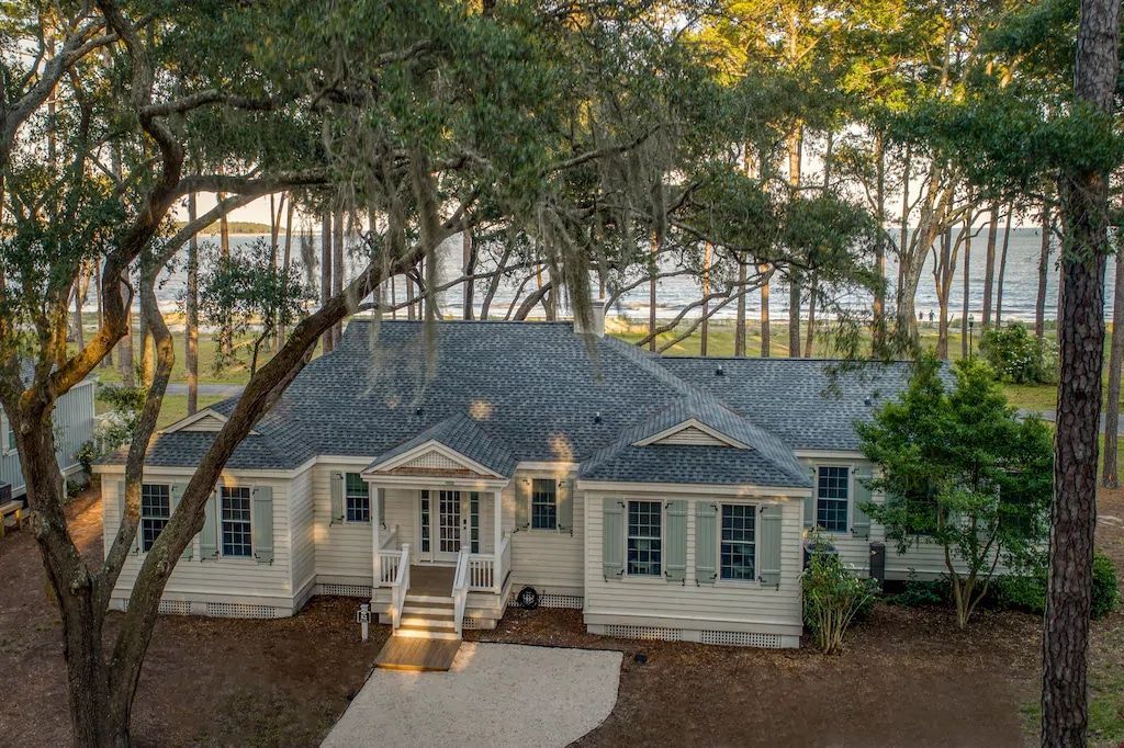 An aerial view of a large white house surrounded by trees.