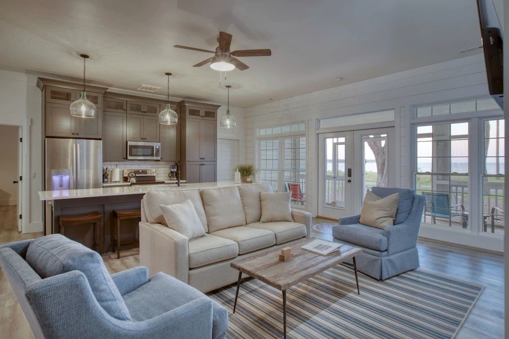 A living room filled with furniture and a ceiling fan.