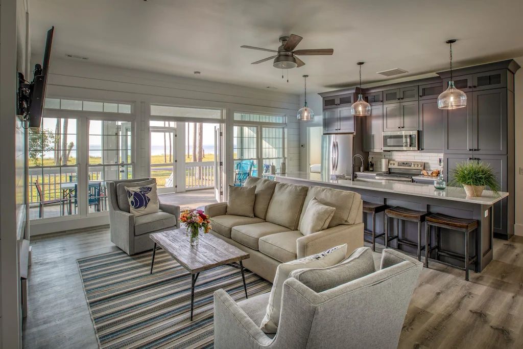 A living room filled with furniture and a ceiling fan.
