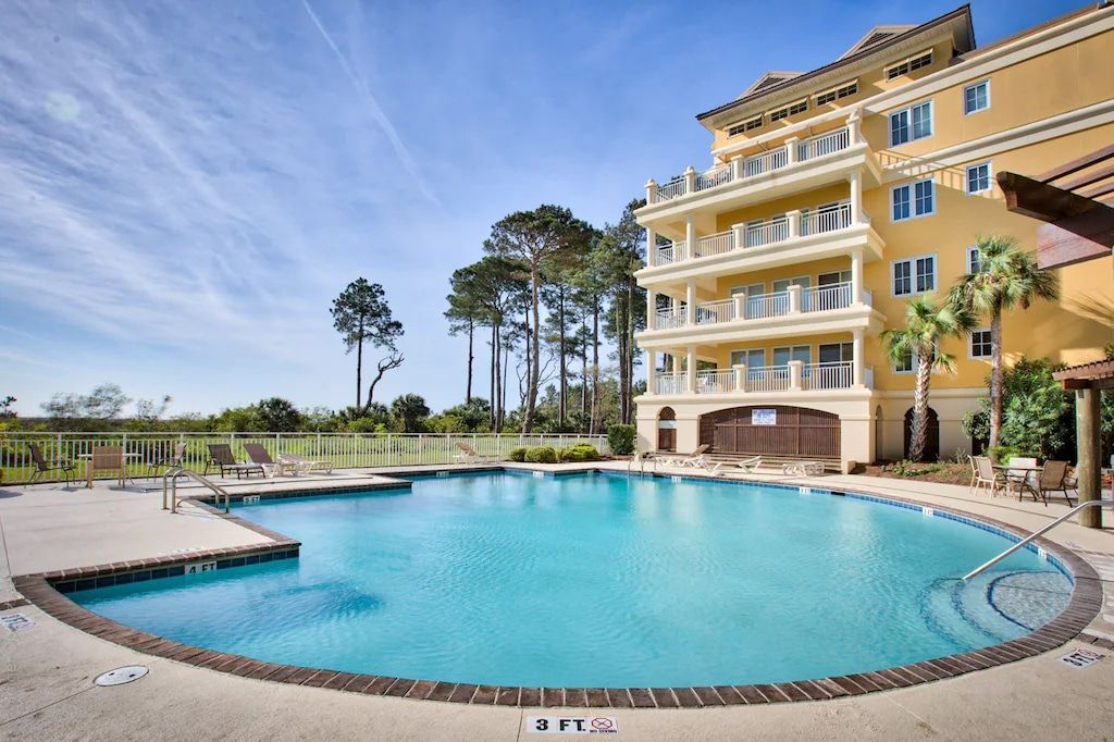 A large swimming pool in front of a large building