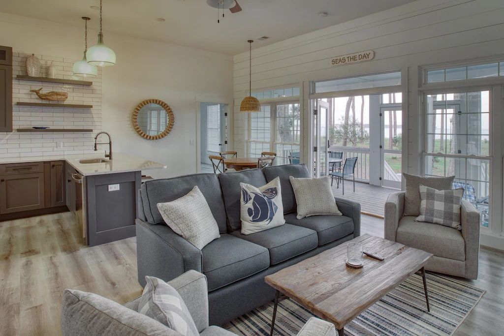 A living room with a couch , chairs , and a coffee table.