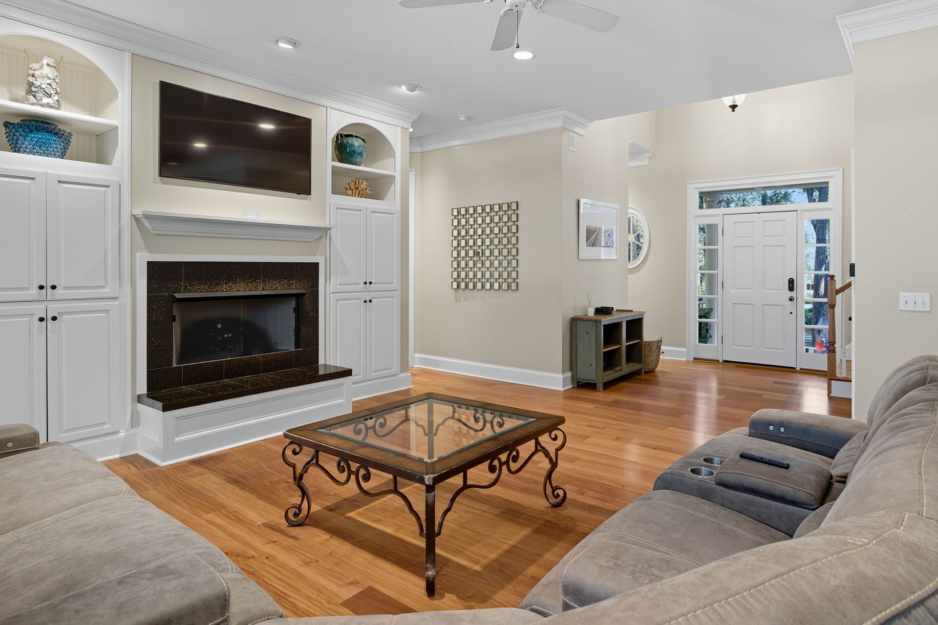 A bedroom with a king size bed and a ceiling fan.
