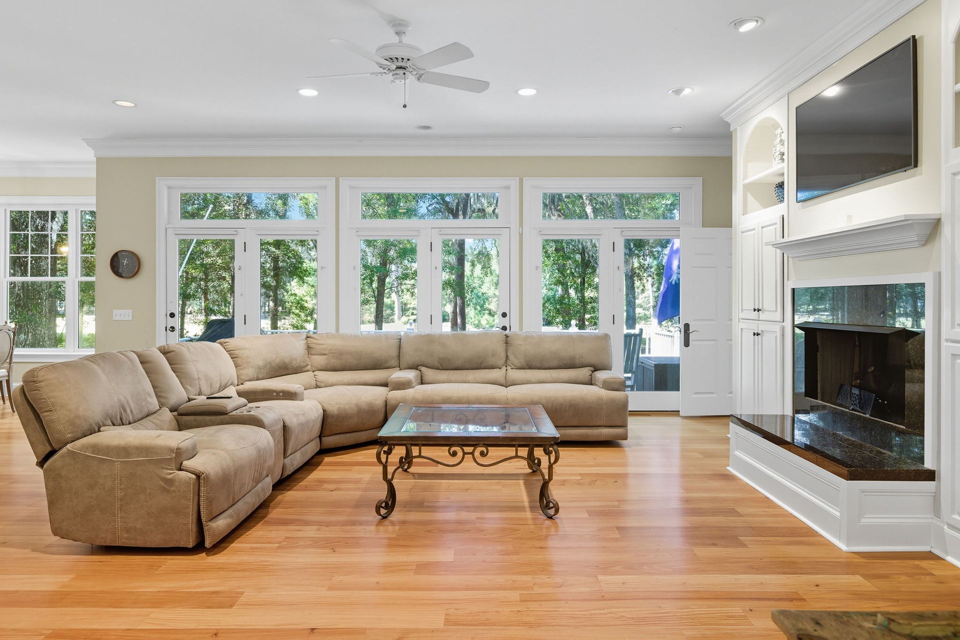 A kitchen with gray cabinets , stainless steel appliances , a sink , and a microwave.