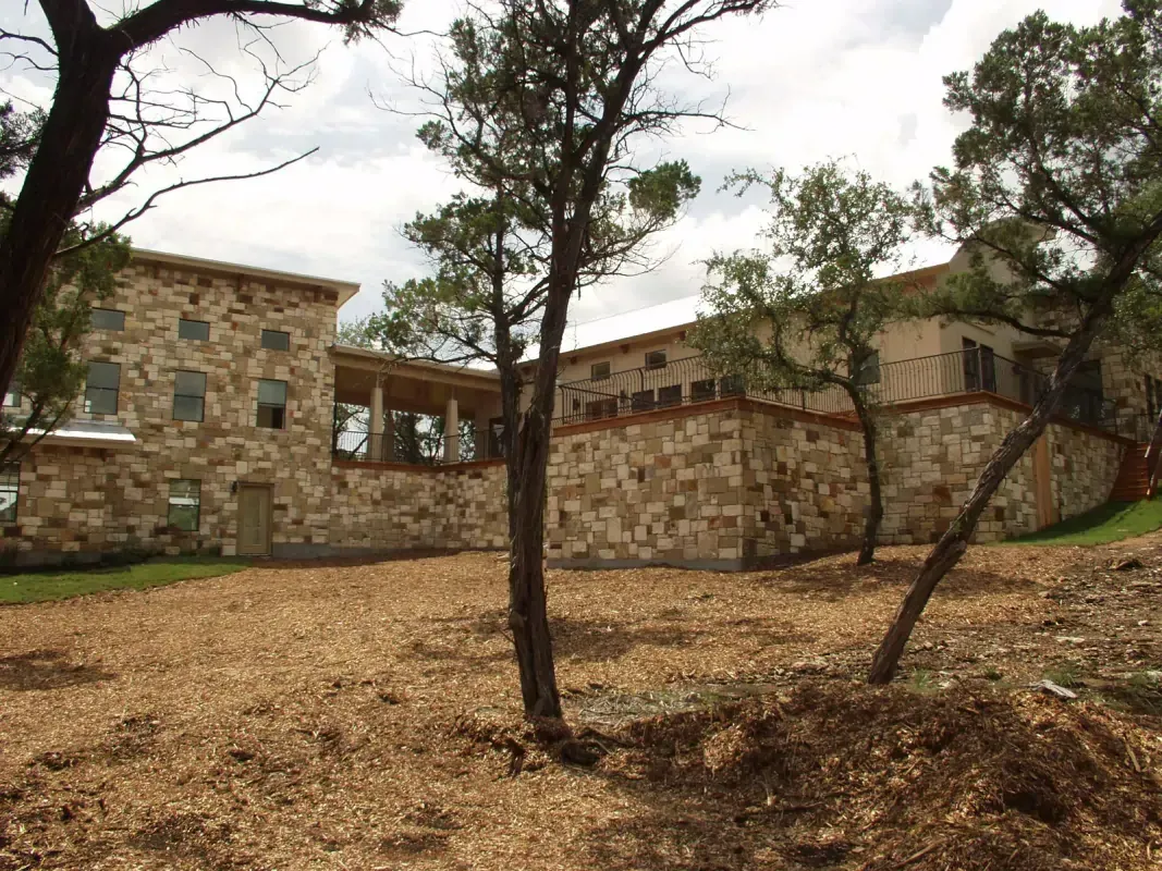 A large stone building with trees in front of it