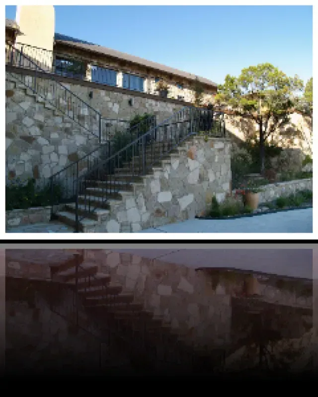 A stone building with stairs leading up to it