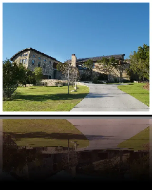 A large house with a driveway leading to it