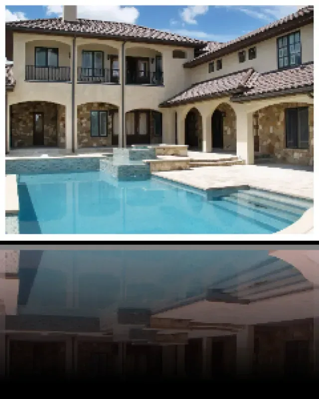A large house with a large swimming pool in front of it