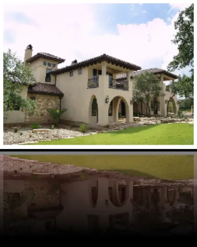 A picture of a house with a reflection of the house in the water