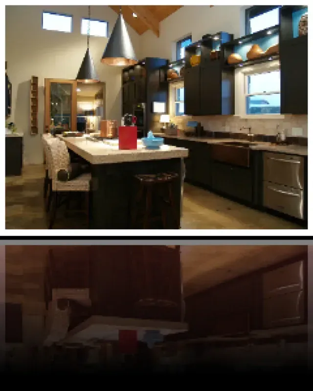 A kitchen with black cabinets and stainless steel appliances