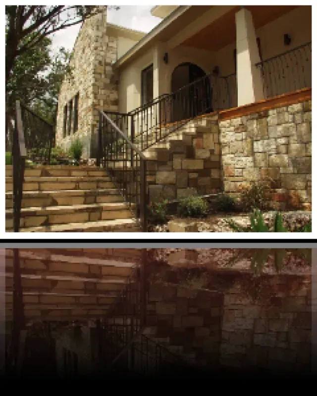 A stone house with stairs leading up to it