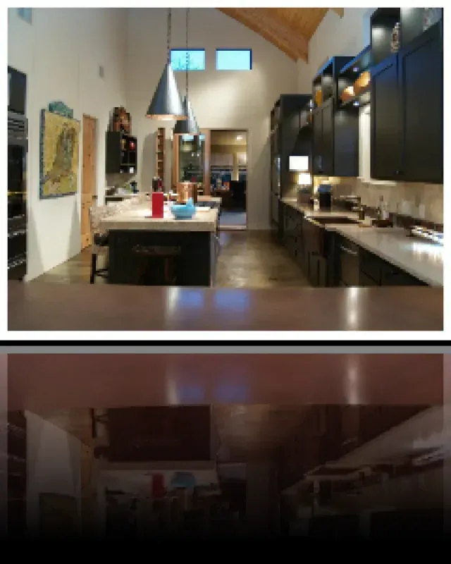 A kitchen with black cabinets and stainless steel appliances