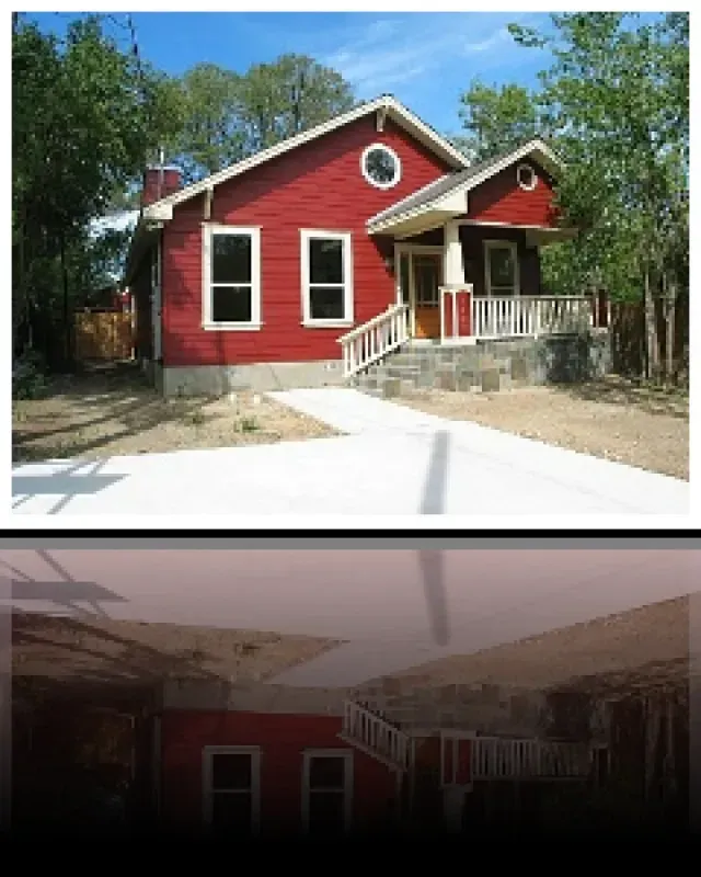A picture of a red house with white trim