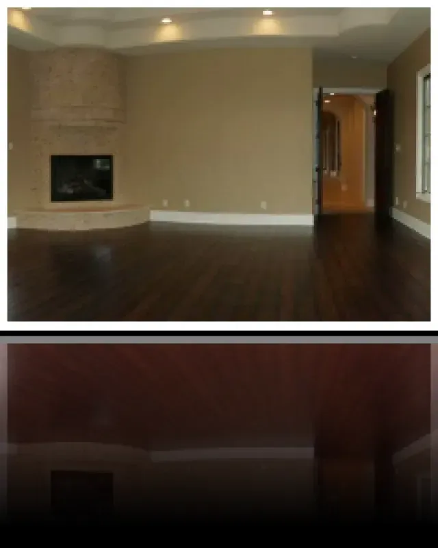 A picture of an empty living room with a fireplace