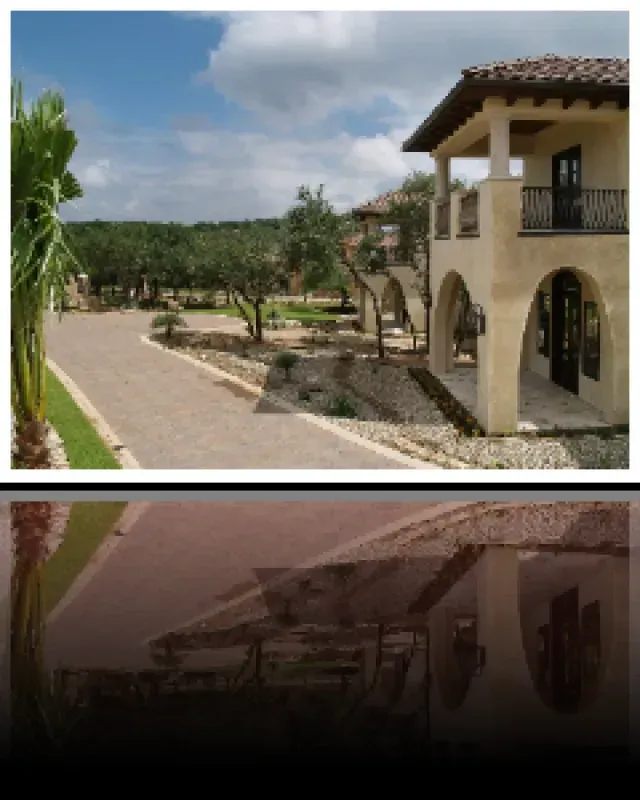 A picture of a house with a reflection of the house in the water