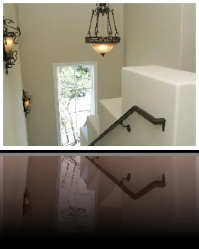 A picture of a staircase with a light hanging from the ceiling