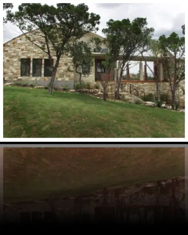 A picture of a house with trees in front of it