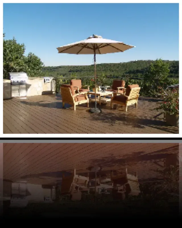 A deck with a table and chairs under an umbrella