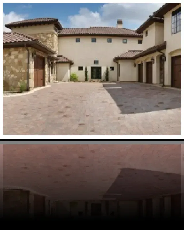 A large house with a brick driveway in front of it