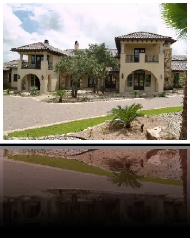 A large house with a reflection of the house in the water