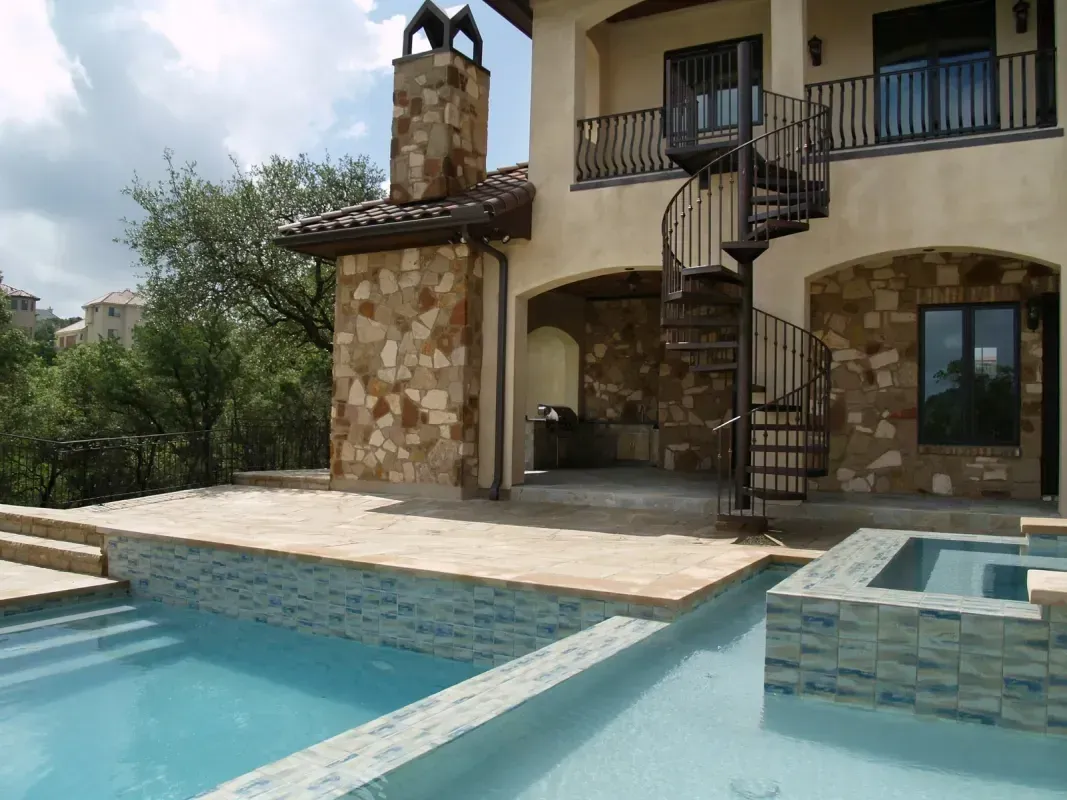 A large house with a spiral staircase and a swimming pool